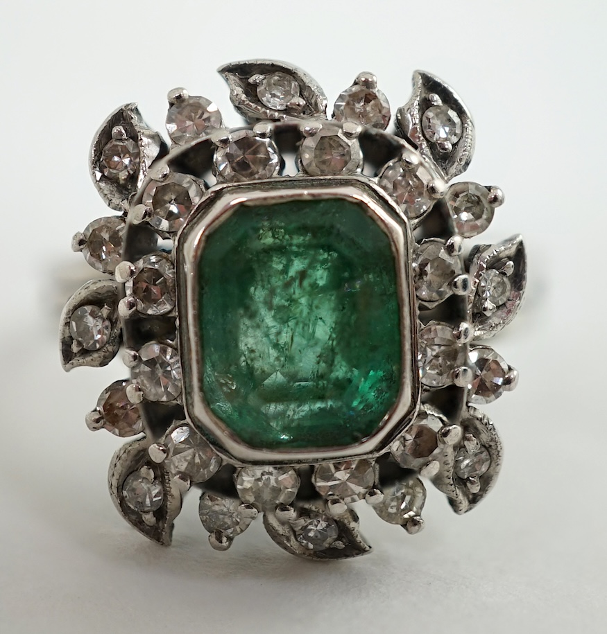 A 1960's white gold, emerald and diamond cluster set dress ring